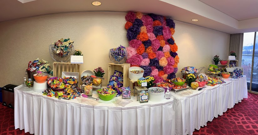 A large table with candy and other snacks